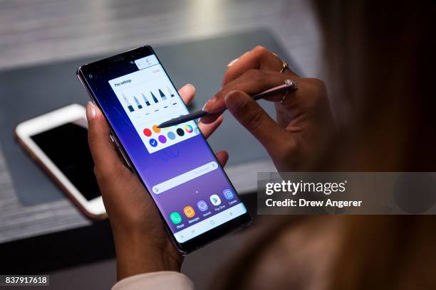 Woman tries the new Samsung Galaxy Note8 smartphone during a launch event, August 23, 2017 in New York City. The Galaxy Note8 will be released in...