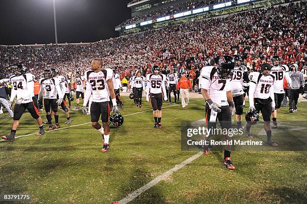 Safety Darcel McBath and the Texas Tech Red Raiders walk off the field after a 65-21 loss against the Oklahoma Sooners at Memorial Stadium on...