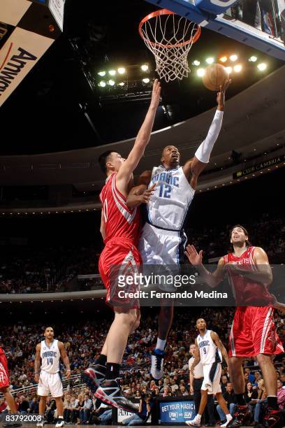 Dwight Howard of the Orlando Magic shoots against Yao Ming of the Houston Rockets on November 22, 2008 at Amway Arena in Orlando, Florida. NOTE TO...