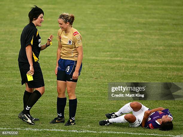 Danielle Calautti of the Glory lays down as Sanna Frostevall of the Jets is given a yellow card by referee Kate Jacewicz during the round five...