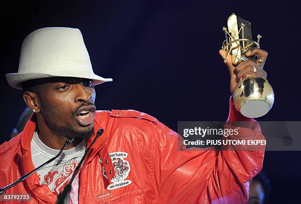 Nigeria's hip-hop artiste 9ice speaks after collecting his award during the MTV Awards ceremony at the Veldrome in Abuja on November 22, 2008. The...