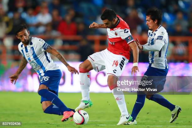 Cristian Pellerano of Veracruz struggles for the ball with Robert Herrera and Jorge Hernandez of Pachuca during the sixth round match between Pachuca...