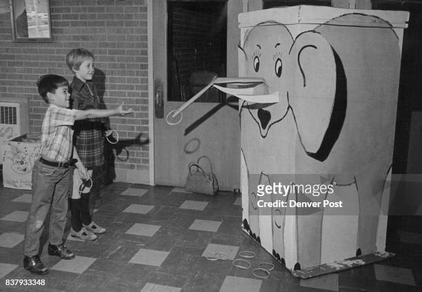 Carnival Ring Toss Targets Gary Fink and Lauri Opperman, students at Eiber Elementary School, 1395 Independence St., Lakewood, try to ring the tusks...