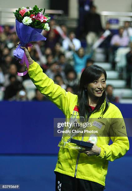 Zhang Ning of China acknowledges the crowd during a ceremony to announce her retirement after playing her last singles badminton match during the...