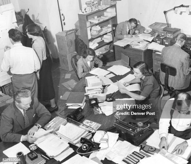 Here's the cubbyhole office of the rapidly-growing University of Denver Press. Around the tables in the forceground are Alan Swallow, Director: Miss...