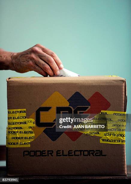 Man casts his vote at a polling station in Caracas, during Venezuela's municipal elections on November 23, 2008. Venezuelans began voting for...