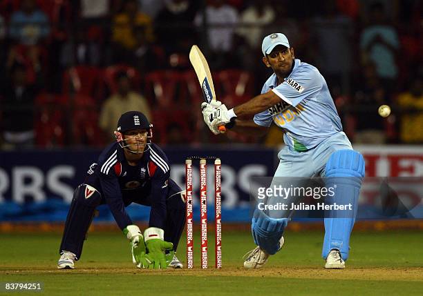 Mahendra Singh Dhoni of India attacks the bowling of Graeme Swann during the 4th One Day International between India and England played at The...