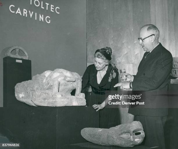 Studying Stone Exhibits - Chandler Weaver points out to Mrs. Weaver some of the unusual features in a Toltec stone carving of an ancient serpent's...