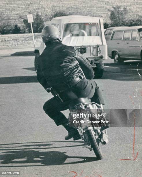 Patrolman Del Black arrives at Abraham Lincoln High School on his minibike, above. At left, he talks with Lincoln student Anthony Hernandez between...