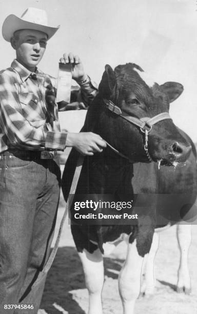 Fred Szymanski of Parker shows his grand champion 4-H dairy animal after judging at the Douglas County fair on Friday. Credit: Denver Post