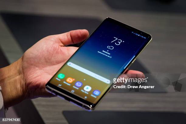 Man tries the new Samsung Galaxy Note8 smartphone during a launch event, August 23, 2017 in New York City. The Galaxy Note8 will be released in...
