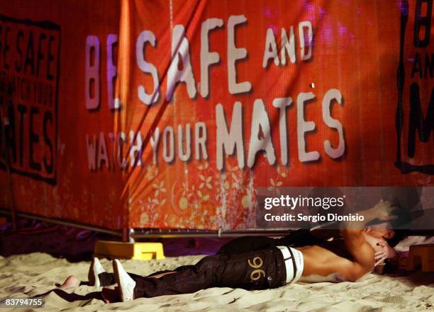 Graduating year 12 school leaver passes out along the fence line during the Schoolies week celebrations in Surfers Paradise on November 23, 2008 on...