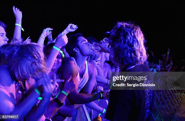 Support team member provides drinking waters to graduating year 12 school leavers during the Schoolies week celebrations in Surfers Paradise on...