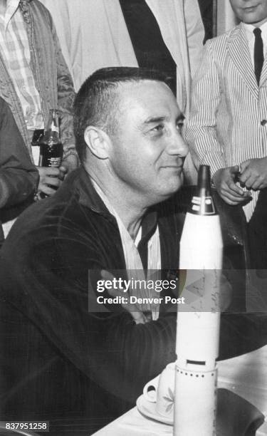 Maj. Virgil l. , Grissom, a Denver Dollar hanging around his neck, holds a press conference at the terminal building at the Gunnison airport. Credit:...