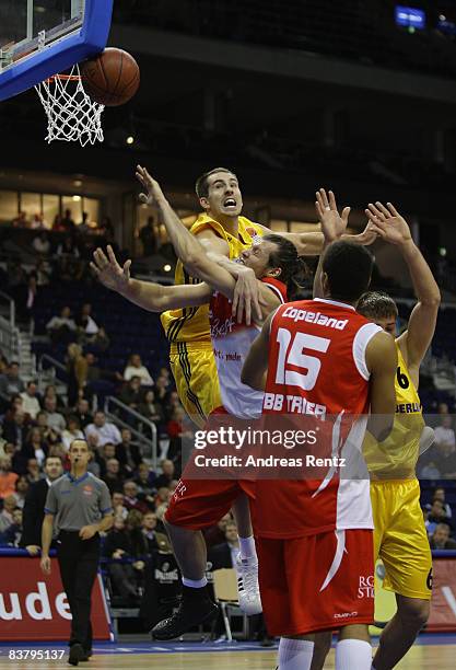 Adam Chubb of Berlin vies for the ball with Maksym Shtein and Christopher Copeland of Trier during the Basketball Bundesliga match between Alba...