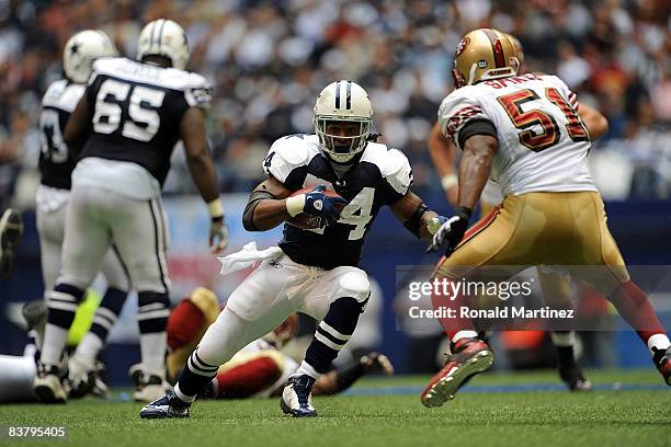 Running back Marion Barber of the Dallas Cowboys runs the ball against Takeo Spikes of the San Francisco 49ers at Texas Stadium on November 23, 2008...