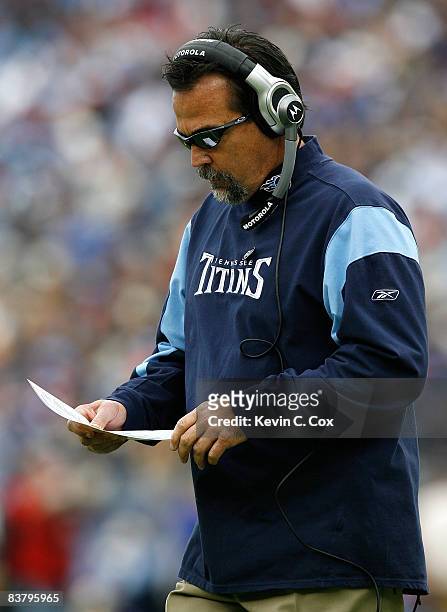 Head coach Jeff Fisher of the Tennessee Titans looks at his playbook against the New York Jets during the game at LP Field on November 23, 2008 in...