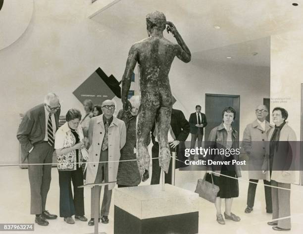 Denver Art Museum visitors study bronze statue of "Victorious Young Athlete." In November 1977 the Colorado and Denver tax departments assessed...