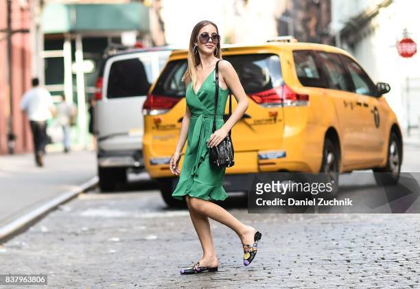 Rosa Crespo is seen in Soho wearing an Iorane green dress, Saint Laurent bag and Etta Sabater shoes on August 22, 2017 in New York City.