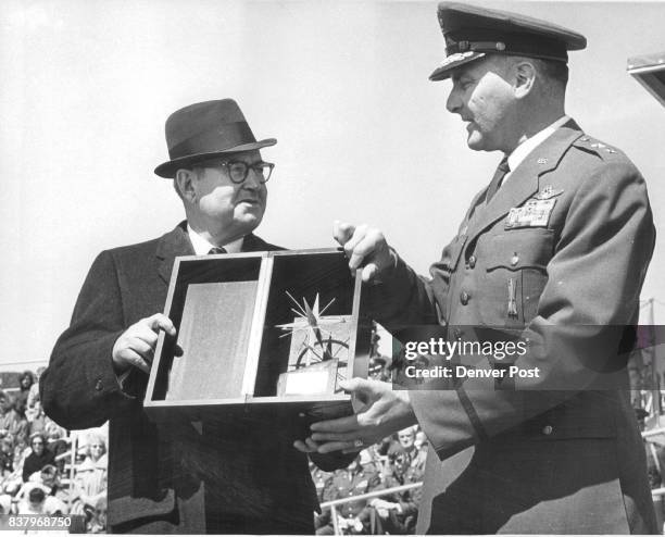 Retired Gen. Curtis E. Lemay, left, receives the 1965 Thomas D. White national defense award from Maj. Gen. Robert H. Warren, Air Force Academy...