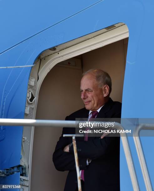 White House chief of staff John Kelly looks out from Air Force One as he arrives with US President Donald Trump in Reno, Nevada on August 23 where...