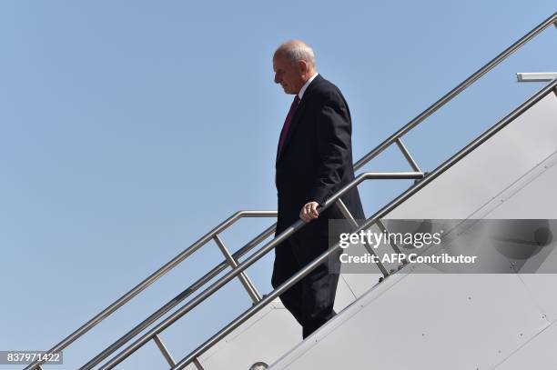 White House chief of staff John Kelly walks from Air Force One as he arrives with US President Donald Trump in Reno, Nevada on August 23 where...