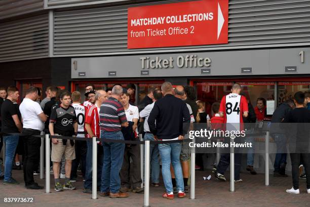 Fans collect their tickets from the ticket office prior to the Carabao Cup Second Round match between Southampton and Wolverhampton Wanderers at St...