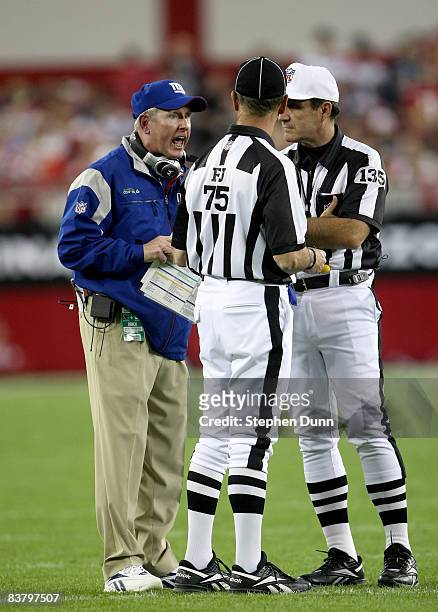 Head coach Tom Coughlin the New York Giants compalins to officials Ron Vernatchi and Peter Morelli during the game with the Arizona Cardinals on...