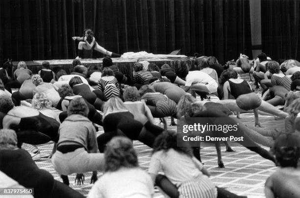 Jane Fonda, on stage, leads a class of more than 200 persons through a strenuous workout Friday at the Regency Hotel. Credit: The Denver Post