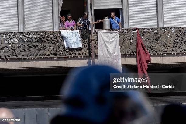 Refugees with gas cylinders on a balcony of the palace as they protest whend police try to remove refugees who camped in Piazza Indipendenza Gardens...