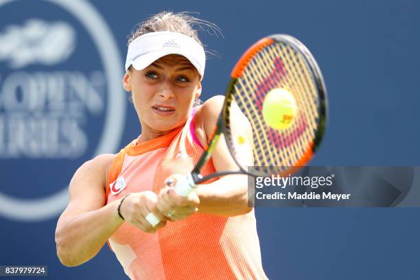 Ana Bogdan of Romania returns a shot to Kirsten Flipkens of Belgium during Day 6 of the Connecticut Open at Connecticut Tennis Center at Yale on...