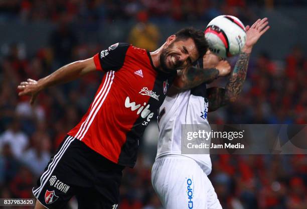 Facundo Erpen of Atlas and Jonathan Fabbro of Lobos BUAP jump for a header during the 6th round match between Atlas and Lobos BUAP as part of the...