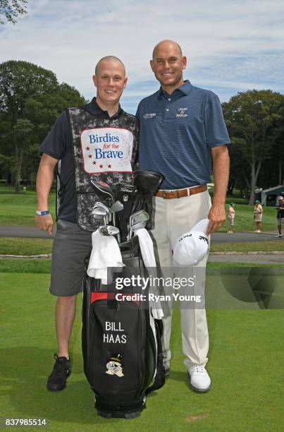 Bill Haas poses with his Military Caddie during practice for the THE NORTHERN TRUST at Glen Oaks Club on August 23 in Old Westbury, New York.