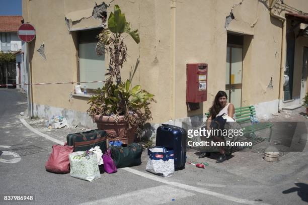 Citizen leaves the red zone affected by the earthquake of yesterday after recoverd her property on August 23, 2017 in Casamicciola Terme, Italy. A...