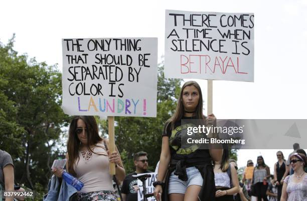 Demonstrators hold signs during an anti-racism rally in front of the U.S. Embassy in Ottawa, Ontario, Canada on Aug. 23, 2017. The peaceful gathering...