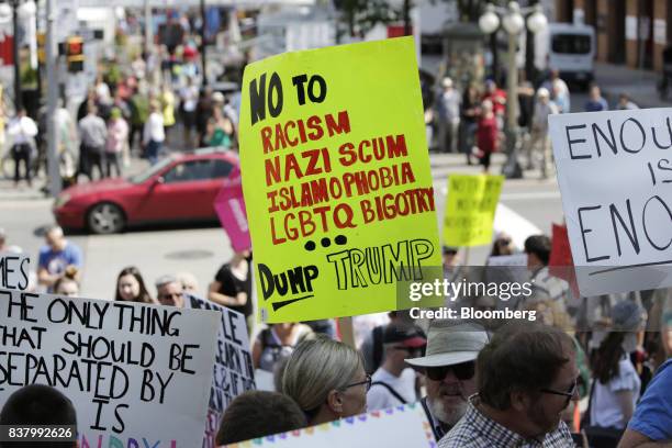 Demonstrators hold signs during an anti-racism rally in front of the U.S. Embassy in Ottawa, Ontario, Canada on Aug. 23, 2017. The peaceful gathering...