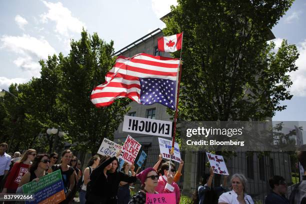 Demonstrator carries an upside down American flag during an anti-racism rally in front of the U.S. Embassy in Ottawa, Ontario, Canada on Aug. 23,...