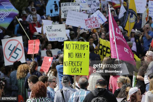 Demonstrators hold signs and wave flags during an anti-racism rally in front of the U.S. Embassy in Ottawa, Ontario, Canada on Aug. 23, 2017. The...