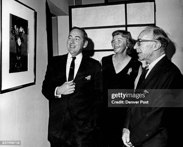 Denver art Museum Opens Metropolitan Exhibition with Reception Mr. And Mrs. E. Atwill Gilman, left, show painting they purchased to Charles Sterne at...