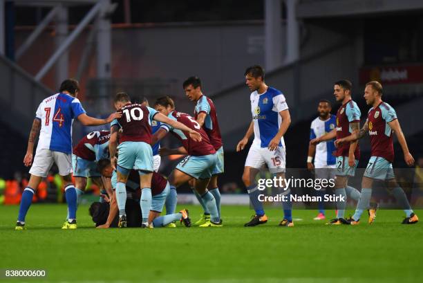 Ashley Westwood of Burnley takes a Blackburn fan down during the Carabao Cup Second Round match between Blackburn Rovers and Burnley at Ewood Park on...