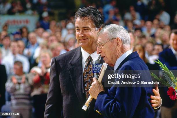 John Wooden and Gail Goodrich hug during Gail Goodrich's Jersey Retirement prior to a game between th Los Angeles Lakers and the Utah Jazz on...