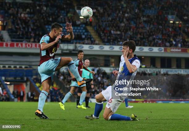 Blackburn Rovers' Richard Smallwood and Burnley's Ashley Westwood during the Carabao Cup Second Round match between Blackburn Rovers and Burnley at...