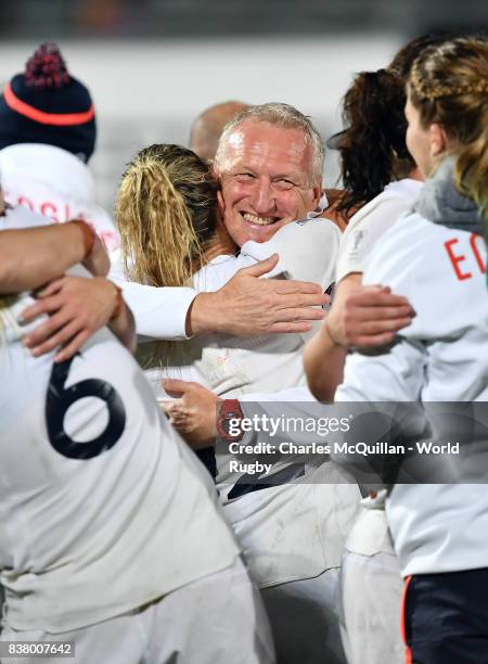 England head coach Simon Middleton hugs his players after the Womens Rugby World Cup semi-final between England and France at the Kingspan Stadium on...