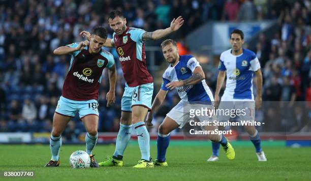 Burnley's Ashley Westwood and Phillip Bardsley shield the ball from Blackburn Rovers' Harry Chapman during the Carabao Cup Second Round match between...