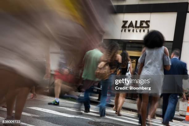 Pedestrians pass in front of a Zales Jewelers store, a subsidiary of Signet Jewelers Ltd., in New York, U.S., on Wednesday, Aug. 23, 2017. Signet...
