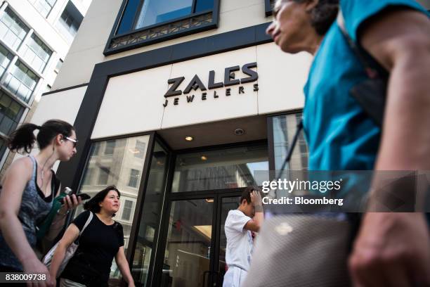 Pedestrians walk past a Zales Jewelers store in New York, U.S., on Wednesday, August 23, 2017. Mark Kauzlarich/Bloomberg via Getty ImagesSignet...