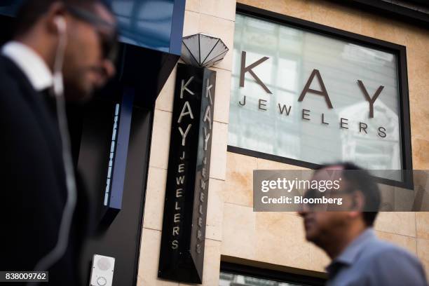 Pedestrians pass in front of a Kay Jewelers store, a subsidiary of Signet Jewelers Ltd., in New York, U.S., on Wednesday, Aug. 23, 2017. Signet...