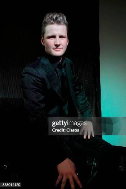 Mexican singer and songwriter Alexander Acha poses for pictures during his new single 'Perdon' presentation on August 17, 2017 in Mexico City,...