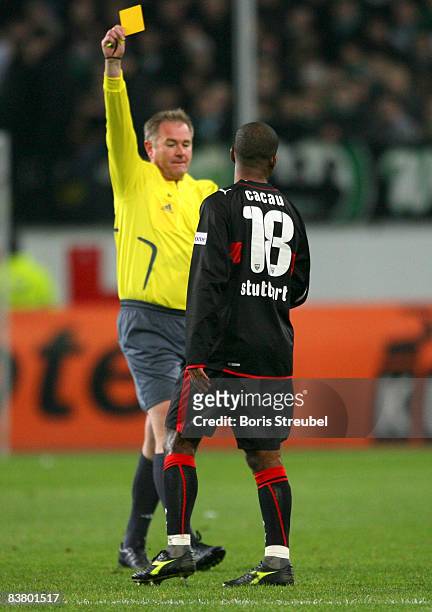 Referee Dr. Helmut Fleischer shows the yellow card to Cacau during the Bundesliga match between VfL Wolfsburg and VfB Stuttgart at the Volkswagen...