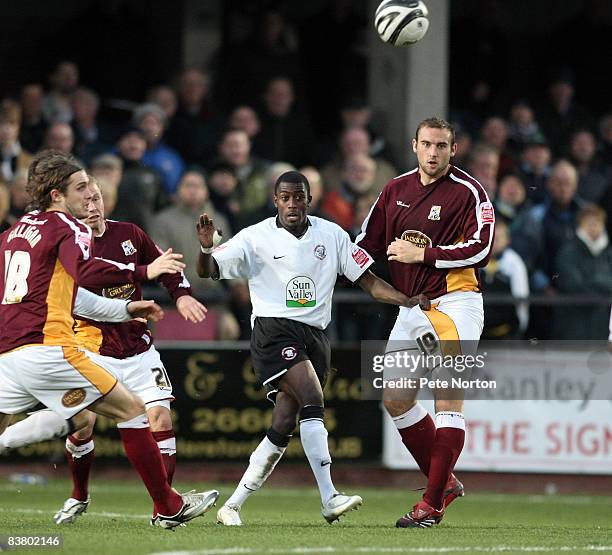 Bradley Hudson-Odoi of Hereford United plays the ball between Liam Dolman and Ryan Gilligan of Northampton Town during the Coca Cola League One Match...
